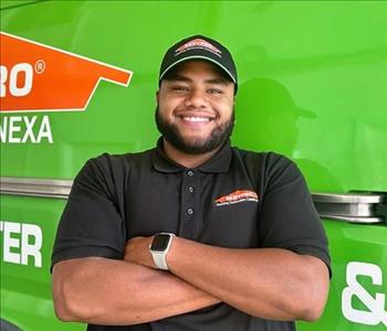 Project Manager Standing in front of Servpro Fleet